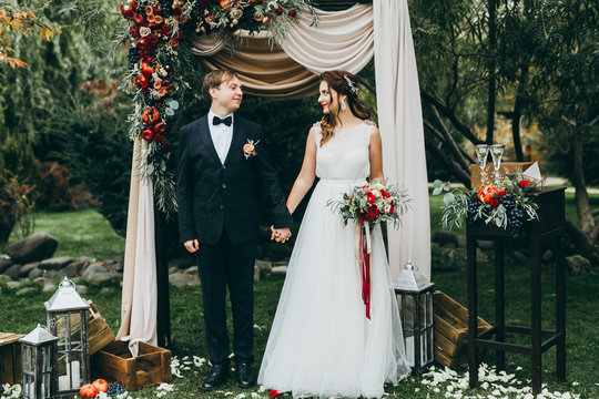 Elegant wedding couple in the autumn park
