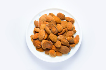Top view of  Almonds in white small dish isolated on white background