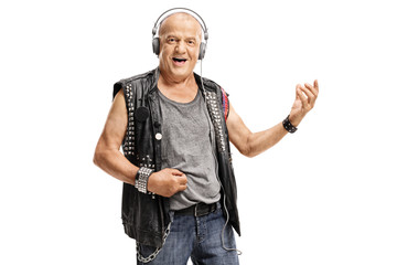 Elderly punker wearing headphones and playing air guitar