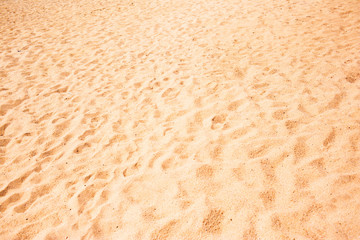 Fototapeta na wymiar Beach sand as background. Yellow and brown Grain Sandy texture close up .