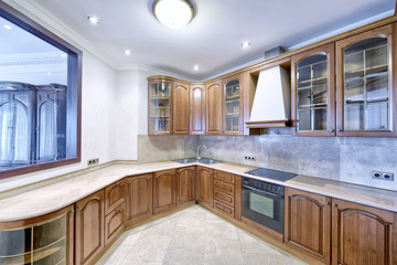 The kitchen is solid wood in a classic style in a modern house.
