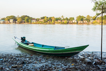 Fototapeta na wymiar Homemade motorboat landed at a Burmese fishing village on early morning, near Yangon, Irrawaddy delta, Myanmar