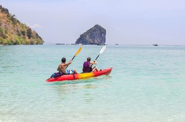 Couple paddling kayak in the andaman sea 