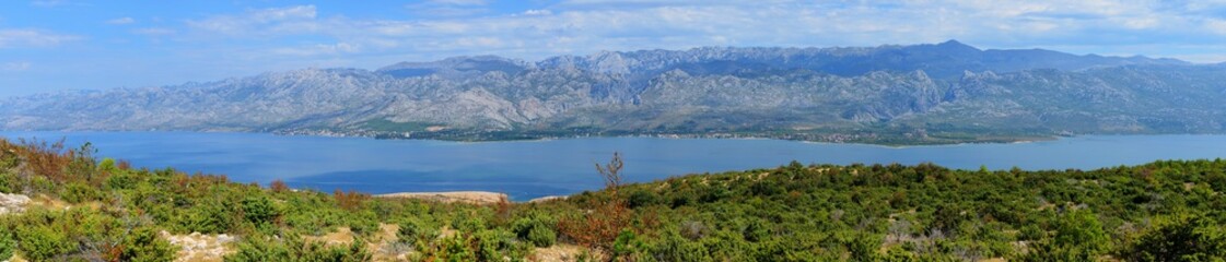 Fototapeta na wymiar Panorama of Velebit mountains. Sveto Brdo, Vaganski vrh, Paklanica. Seline, Starigrad, Modric. Croatia. View from island Pag.