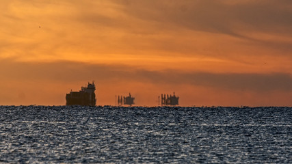 Fototapeta premium Mystical sunset on the Baltic Sea. The water area of the port of Klaipeda, Lithuania