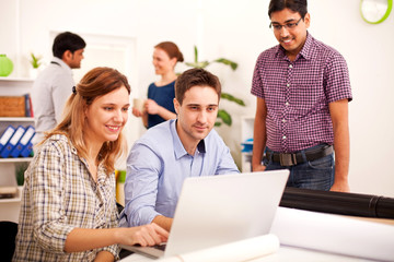Young business people enjoying working  in the office