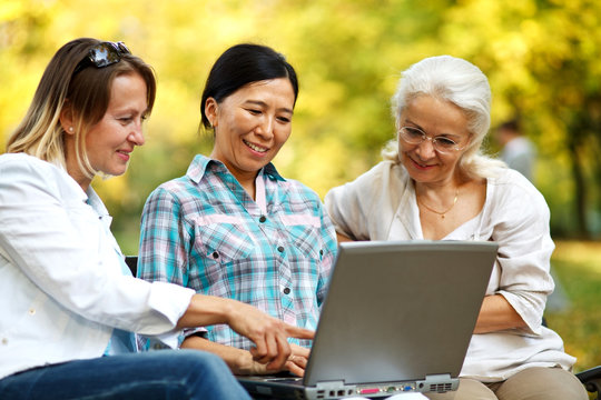 Mature women reading on a laptop