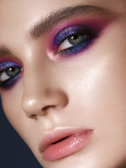 Obraz premium Beautiful young model with fashion make up, perfect skin. Trendy colorful smoky eyes. Lilac smoky eyes