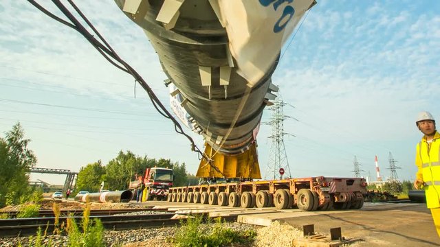 Timelapse Crane Takes Away Pipe and Lorry Transports Tower