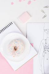 top view of sketch, donut and office supplies at fashion designer workplace
