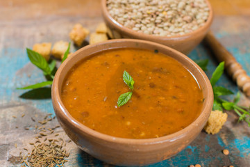 Homemade red lentils soup in yellow bowl