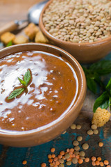 Homemade red lentils soup in yellow bowl