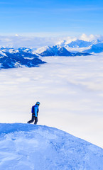 Fototapeta na wymiar Tourist on top of the mountain of the ski resort Soll, Tyrol, Austria