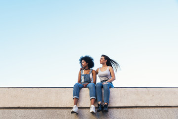 Beautiful women seating in the street.