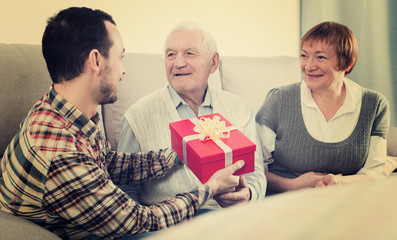 Son giving presents to parents