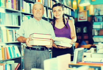 Glad old man with girl are showing purchases
