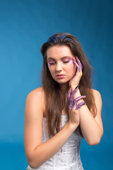 Fototapeta premium Studio beauty portrait of attractive woman with creative make-up and glitter and spangle on her face and hands.Face art.