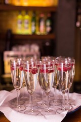 welcome drink for a party - a glass of prosecco with raspberry inside