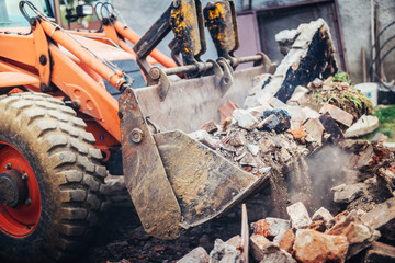 Industrial Hydraulic crusher excavator backoe machinery working on site demolition