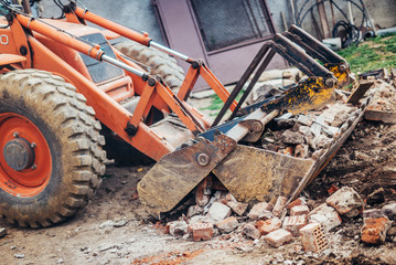 Fototapeta premium Industrial backhoe crusher loading demolition debris
