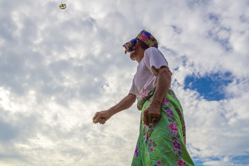 Unidentified man is playing the traditional moon kite or locally known as "Wau Bulan" in Kelantan, Malaysia.