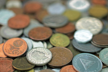 Mixed world currency coins, Swiss Franc and Cordoba Oro Nicaragua in focus