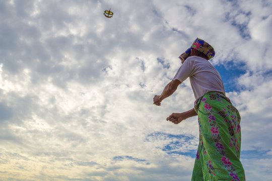 Unidentified Man Is Playing The Traditional Moon Kite Or Locally Known As 