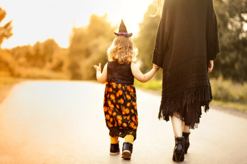 Little witch and her mother, trick or treat