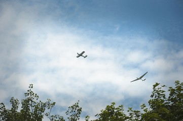 a glider hauled by plane against blue sky