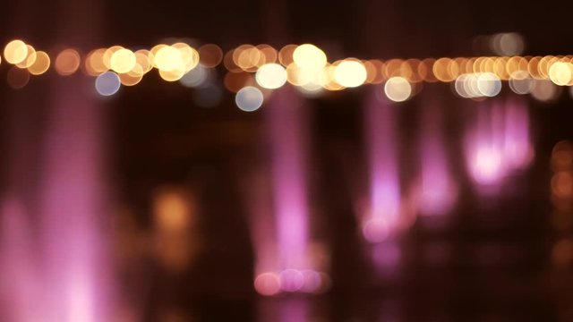 Water fountains and city lights at night