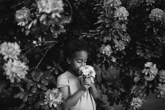 A girl smelling flowers in garden