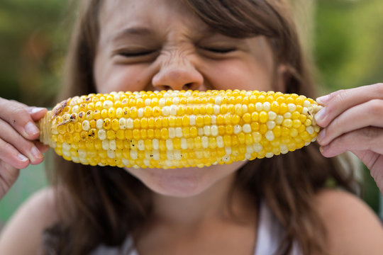 Girl eating corn on the cob