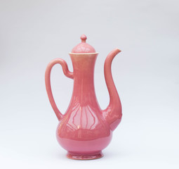 Pink porcelain kettle on white background