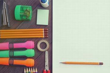 school exercise book with pencils and markers