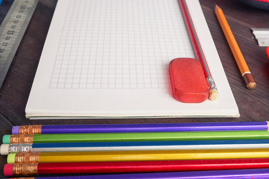 school notepad with colorful pencils