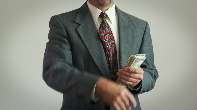 4K: Businessman Throwing Money At Camera