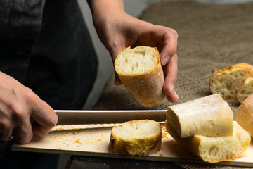 woman sliced French fresh bread baguette with poolish, shallow dof