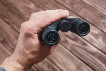 Hand with binoculars.