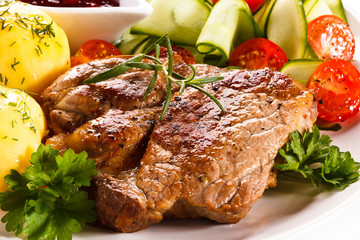 Fried steak, boiled potatoes and vegetable salad