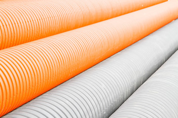 Construction orange and black plastic pipes