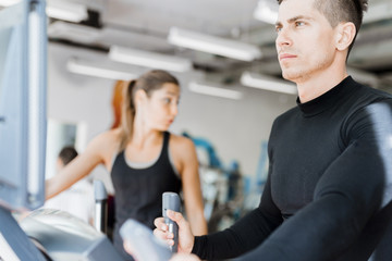 Young healthy group of people working out on a elliptic trainer
