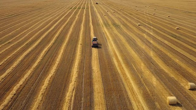 Flying over beautiful field with bale of hay. Aerial drone footage 4k