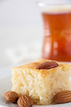 Basbousa Traditional Arabic Semolina Cake with Nuts Orange Blossom Water Vertical Copy space White background