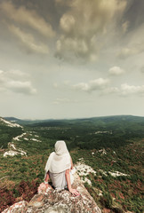 A beautiful landscape and a cloudy sky. Pine and deciduous forest on the slopes of the hill