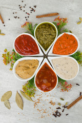 Tasty fresh sauces in a form of flower with spices. Cooking from natural ingredients.