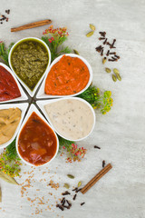Tasty fresh sauces in a form of flower with spices and herbs. Delicious addition to dishes