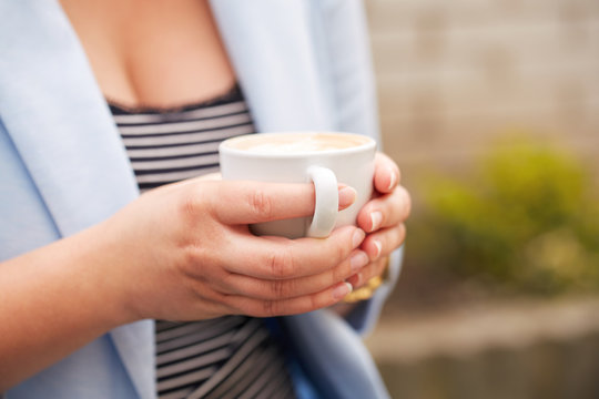 Female hands with a cup of coffee