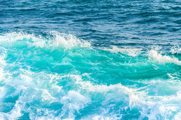 Beautiful blue wave in tropical ocean. Turquoise wave barrel crashing in sea. Close up.
