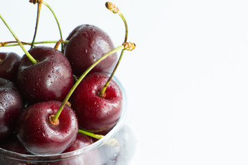 Close up fresh cherry in glass isolated on white background. Copy space. Creative design menu concept. Summer background.