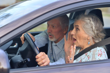 senior couple driving car